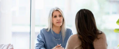Woman talking through budgeting after the loss of a spouse with a professional