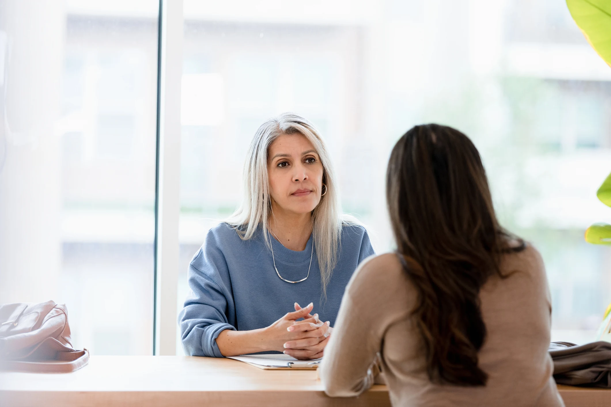 Woman talking through budgeting after the loss of a spouse with a professional