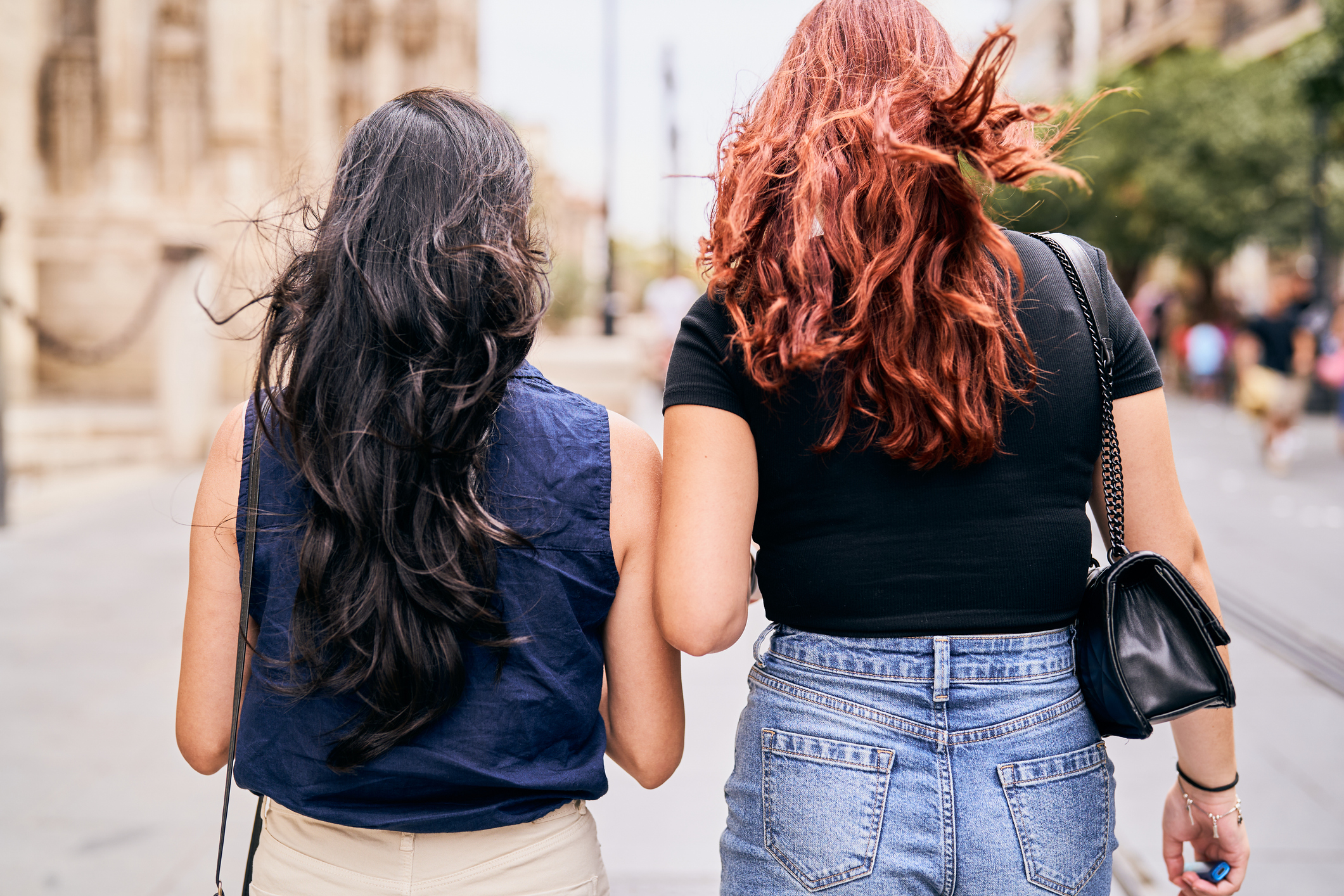 2 girls walking together outside