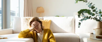 Upset woman in yellow cardigan