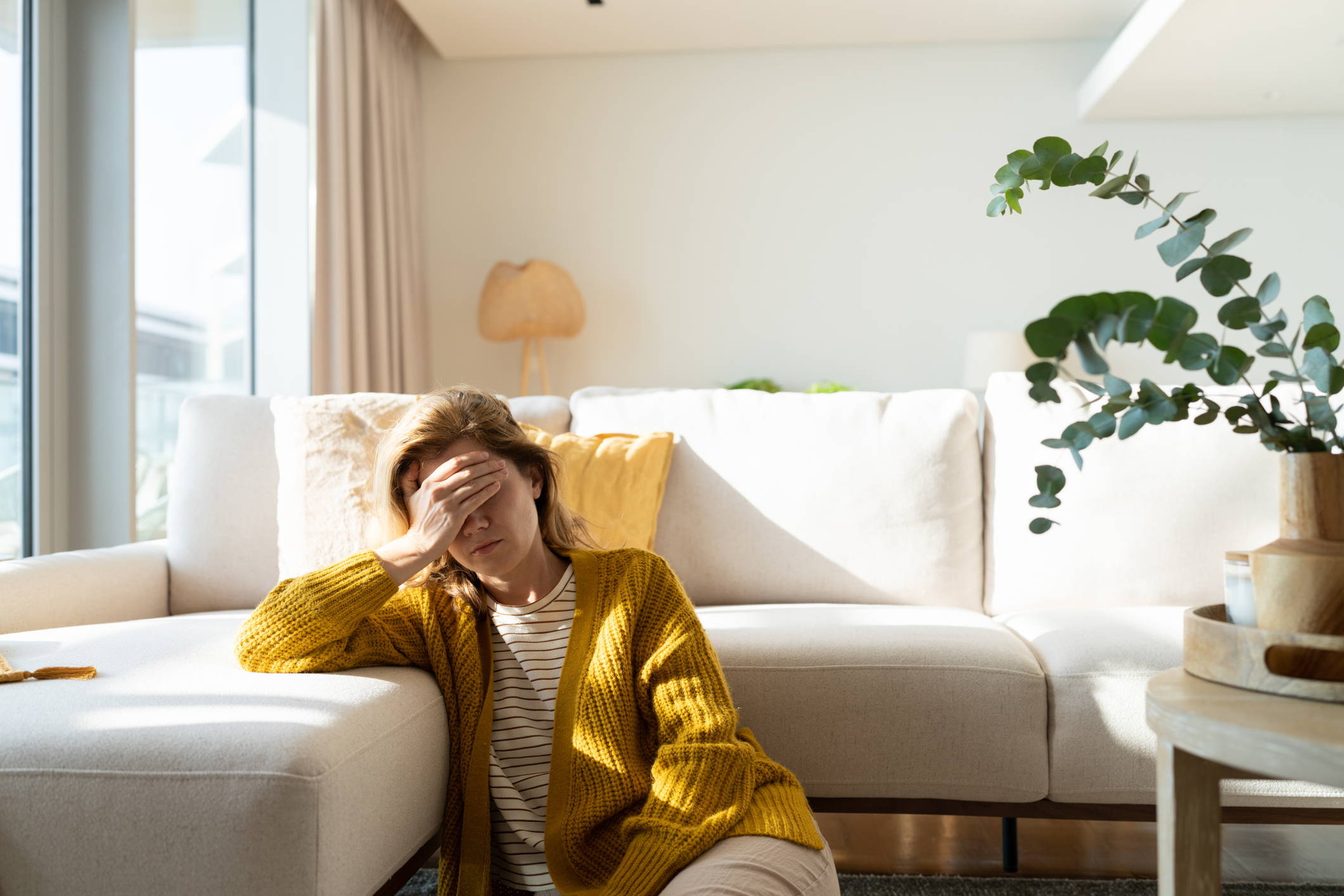 Upset woman in yellow cardigan