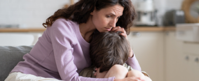 Grieving mom holding sad son